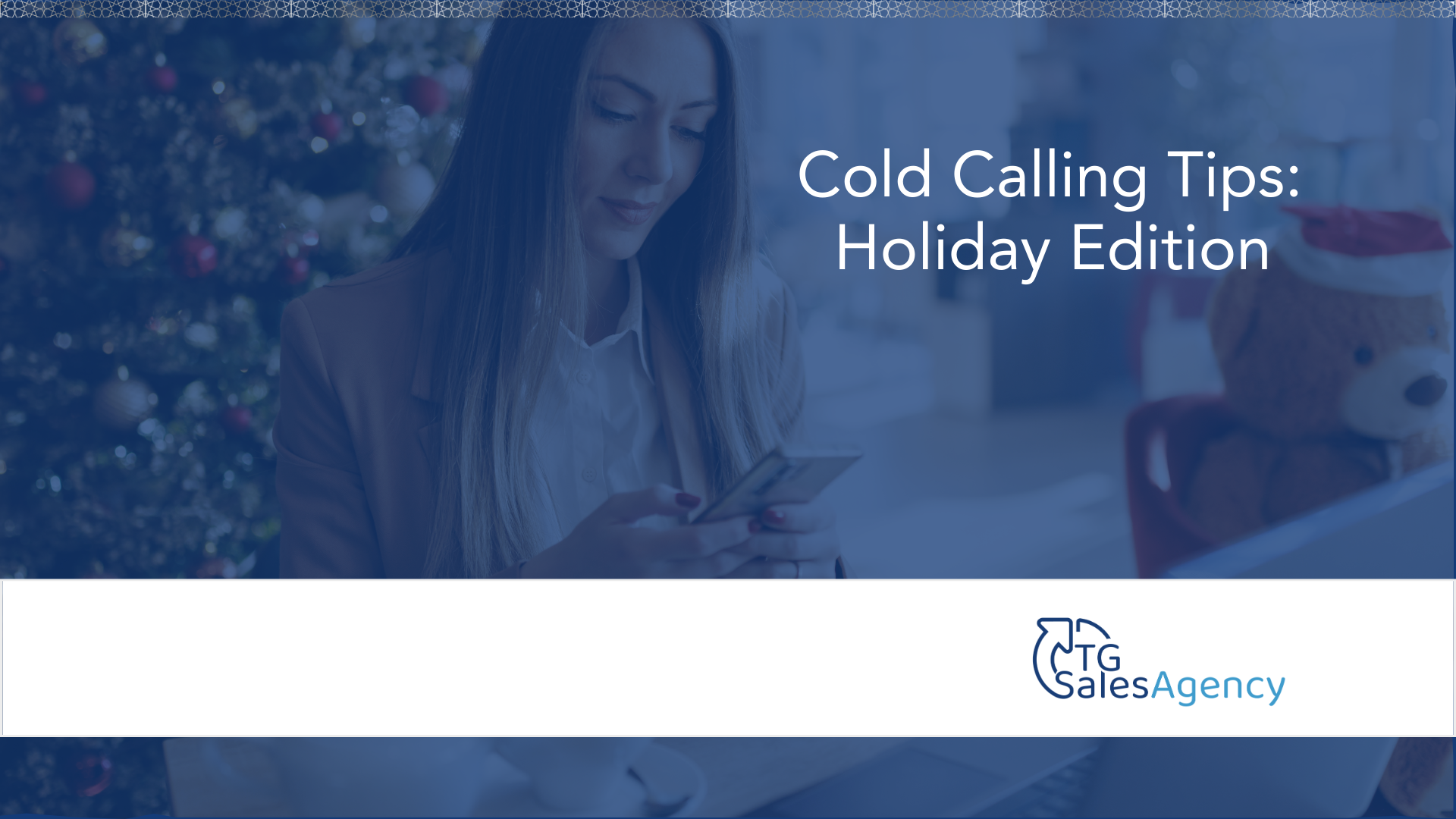 A professional woman checking her phone in a holiday office setting, representing intentional cold calling and sales outreach during the holidays.